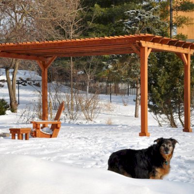 Traditional Wooden Garden Pergola (Options: 20' L x 14' W, Mature Redwood, No Electrical Wiring Trim, Slats at 6" and Rafters at 18", Lengthwise Roof Support Timbers, 4-Post Anchor Kit for Stone, No Ceiling Fan Base, No Privacy Panels, No Curtain Rods, 9' Post Height, Transparent Premium Sealant). Photo Courtesy of Mary Louise and Gerry Neugent of Des Moines, IA.