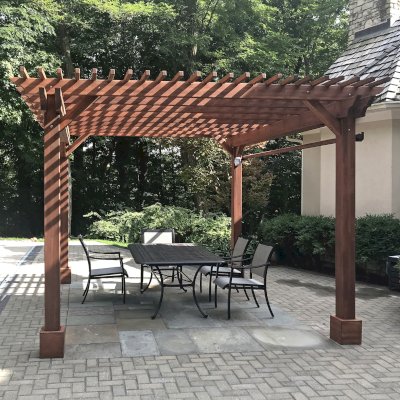 Traditional Wooden Garden Pergola (Options: 14' L x 12' W, Mosaic Douglas-Fir, Viking End Cut Detail, Electrical Wiring Trim for 1 Post, Open Roof with Slats at 6", Rafters at 18", 4-Post Anchor Kit for Concrete, No Ceiling Fan Base, No Privacy Panels, No Curtain Rods, 9' Posts, Coffee-Stain Premium Sealant). Photo Courtesy of J. Hixon of Zionsville, IN.
