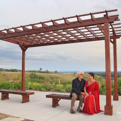 Traditional Wooden Garden Pergola in Sonali's Garden (Options: 20' L x 12' W, California Redwood, No Electrical Wiring Trim, Open Roof with Slats at 18", Rafters at 18", 4-Post Anchor Kit for Concrete, No Ceiling Fan Base, No Privacy Panels, No Curtain Rods, 9' Posts, Coffee Stain Premium Sealant). Photo Courtesy of Vinod & Aruna.