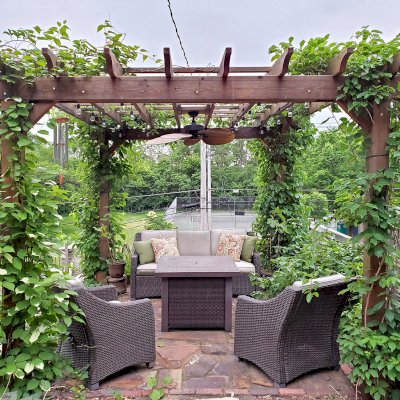 Traditional Wooden Garden Pergola (Options: 14' L x 12' W, Mature Redwood, No Electrical Wiring Trim, Open Roof with Slats at 18", Rafters at 18", Lengthwise Roof Support Timbers, 4-Post Anchor Kit for Concrete, No Ceiling Fan Base, No Privacy Panels, No Curtain Rods, 9' Post Height, Transparent Premium Sealant). Photo Courtesy of D. Vickery of St. Paul, Minnesota.