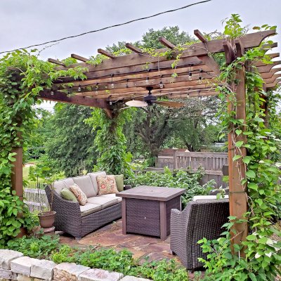 Traditional Wooden Garden Pergola (Options: 14' L x 12' W, Mature Redwood, No Electrical Wiring Trim, Open Roof with Slats at 18", Rafters at 18", Lengthwise Roof Support Timbers, 4-Post Anchor Kit for Concrete, No Ceiling Fan Base, No Privacy Panels, No Curtain Rods, 9' Post Height, Transparent Premium Sealant). Photo Courtesy of D. Vickery of St. Paul, Minnesota.