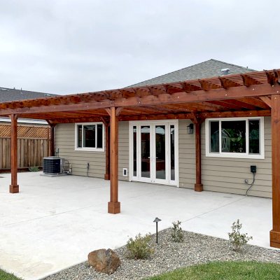 Traditional Wooden Garden Pergola (Options: 42’ L x 16’-3 1/2” W, Old-Growth Redwood by Custom Request, No Electrical Wiring Trim, Open Roof with Slats at 6", Rafters at 18", 8-Post Anchor Kit for Concrete, No Ceiling Fan Base, No Privacy Panels, No Post Decorative Trims, No Curtain Rod, 10' Post Height, Transparent Premium Sealant). Photo Courtesy of D. Menzel of Santa Rosa, CA.