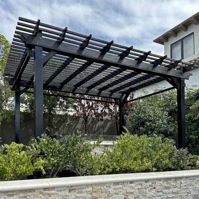 Traditional Wooden Garden Pergola (Options: 15' L x 11' W, Douglas-fir, Electrical Wiring Trim for 1 Post, Open Roof with Slats at 6", Rafters at 18", No Rain Guard,  4-Post Anchor Kit for Concrete, No Ceiling Fan Base, No Privacy Panels, 3 Curtain Rods, 8' Posts, Black Stain Premium Sealant). Photos Taken After Pergola Resealed, 6 Months After Installation. Photo Courtesy of G. Volk of San Diego, CA.