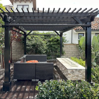 Traditional Wooden Garden Pergola (Options: 15' L x 11' W, Douglas-fir, Electrical Wiring Trim for 1 Post, Open Roof with Slats at 6", Rafters at 18", No Rain Guard,  4-Post Anchor Kit for Concrete, No Ceiling Fan Base, No Privacy Panels, 3 Curtain Rods, 8' Posts, Black Stain Premium Sealant). Photos Taken After Pergola Resealed, 6 Months After Installation. Photo Courtesy of G. Volk of San Diego, CA.