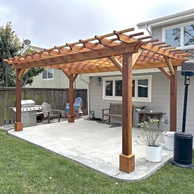 Traditional Wooden Garden Pergola (Options: 18' L x 10' W, California Redwood, No Electrical Wiring Trim, Open Roof with Slats at 12", Rafters at 18", Post Anchor Kit for Concrete, No Ceiling Fan Base, No Privacy Panels, No Curtain Rods, 8' Posts, Transparent Premium Sealant). Photo Courtesy of G. Kelly of Rancho Palos Verdes, CA.