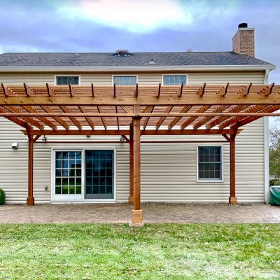 Traditional Wooden Garden Pergola (Options: 26' L x 18' W, Mature Redwood, 2 Electrical Wiring Trims, Open Roof with Slats at 6", Rafters at 18", 6-Post Anchor Kit for Concrete, No Ceiling Fan Base, No Privacy Panels, No Post Decorative Trims, 2 Curtain Rod, 9' Post Height, Transparent Premium Sealant). Photo Courtesy of H. Wittreich of Somerset, New Jersey.