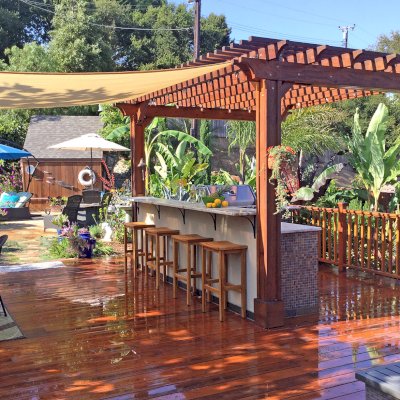 Traditional Wooden Garden Pergola (Options: 14' L x 11' W, Mature Redwood, Electrical Wiring Trim for2 Posts, Open Roof with Slats at 6", Rafters at 18", 4-Post Anchor Kit for Wood, No Ceiling Fan Base, No Privacy Panels, Vertical Post Decorative Trims, No Curtain Rod, 9' Post Height, Transparent Premium Sealant). Photo Courtesy of J. Turner of Santa Barbara, California.