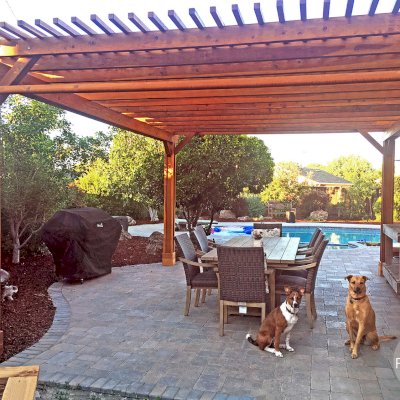 Traditional Wooden Garden Pergola (Options: 20' L x 16' W, California Redwood, 2 Electrical Wiring Trims, Open Roof with Slats at 6", Rafters at 18", 4-Post Anchor Kit for Concrete, 1 Ceiling Fan Base, No Privacy Panels, Vertical Post Decorative Trims, 1 Curtain Rod, 9' Post Height, Transparent Premium Sealant). Photo Courtesy of Jason Irwin of Campbell, California.