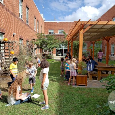 Traditional Wooden Garden Pergola (Options: 30' L x 12' W, Douglas-fir, Open Roof with Slats at 18, Transparent Premium Sealant). Shade clothe is a wonderful way to increase shade when needed. Shade Clothe shown is a custom detail we can add for you. Photo Courtesy of Frederick Douglass Elementary School of Lessburg, Virginia.