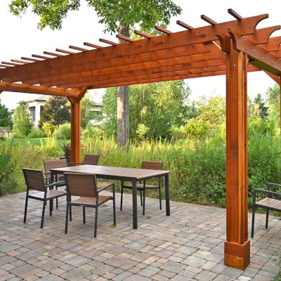 Traditional Wooden Garden Pergola (Options: 20' L x 10' W, California Redwood, No Electrical Wiring Trim, Slats at 12" and Rafters at 18", Vertical Post Decorative Trims, Lengthwise Roof Support Timbers, 4-Post Anchor Kit For Concrete, No Ceiling Fan Base, No Privacy Panels, No Curtain Rods, 8.5' Post Height, Transparent Premium Sealant). Photo Courtesy of E. Weber of Lyndhurst, Ohio.