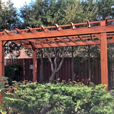 Traditional Wooden Garden Pergola (Options: 14' L x 10' W, California Redwood, No Electrical Wiring Trim, Open Roof with Slats at 18", Rafters at 18", 4-Post Anchor Kit for Concrete, No Ceiling Fan Base, No Privacy Panels, No Post Decorative Trims, No Curtain Rod, 9' Post Height, Transparent Premium Sealant). Photo Courtesy of S. Schmidt of Philadelphia, Pennsylvania.