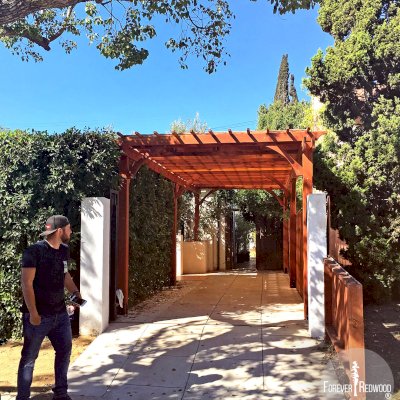  Traditional Wooden Garden Pergola (Options: 30' L x 10' W, California Redwood, No Electrical Wiring Trim, Open Roof with Slats at 12", Rafters at 18", Lengthwise Roof Support Timbers, 4-Post Anchor Kit for Concrete, No Ceiling Fan Base, No Privacy Panels, No Curtain Rods, 9.5' Post Height, Transparent Premium Sealant). Photo Courtesy of Sunday Stevens and David Klein of Los Angeles, California.