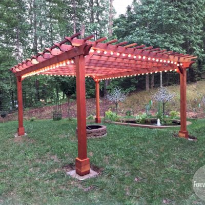Traditional Wooden Garden Pergola (Options: 18' L x 16' W, California Redwood, Electrical Wiring Trim for 1 Post, Open Roof with Slats at 12", Rafters at 18", Lengthwise Roof Support Timbers, 4-Post Anchor Kit for High-Wind, No Ceiling Fan Base, No Privacy Panels, No Curtain Rods, 9' Post Height, Transparent Premium Sealant). Photo Courtesy of A. Miller of Ellijay, Georgia.