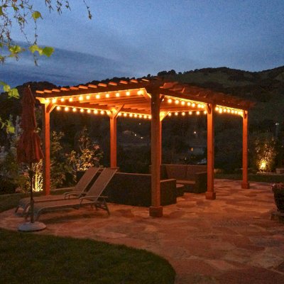 Traditional Garden Pergola (Options: 22' L x 14' W, Mature Redwood, Electrical Wiring Trim for 2 Posts, Open Roof with Slats at 6", Rafters at 18", Widthwise Roof Support Timbers, 6-Post Anchor Kit for Concrete, No Ceiling Fan Base, No Privacy Panels, No Curtain Rods, 9.5' Post Height, Transparent Premium Sealant). Photo Courtesy of Roger Cassidy of Novato, CA.