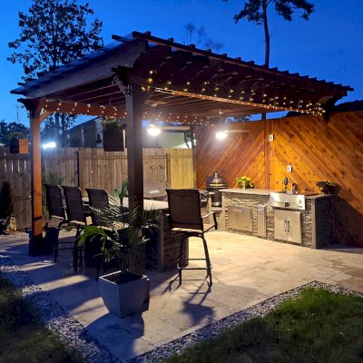 Traditional Wooden Garden Pergola (Options: 18' L x 12' W, California Redwood, 1 Electrical Wiring Trim, Open Roof with Slats at 18", Rafters at 12" by Custom Request, with Rain Guard, 4-Post Anchor Kit for High-Wind, 2 Ceiling Fan Bases, No Privacy Panels, No Curtain Rods, 9.5' Posts, Transparent Premium Sealant). Rafters were designed with a slope for draining purpose. Photo Courtesy of M. McGourty of Virginia Beach, Virginia.