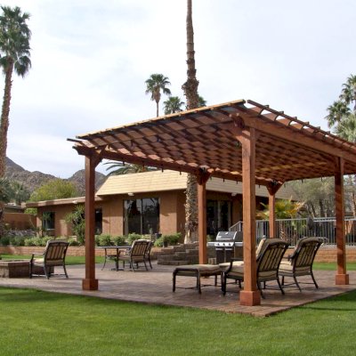 Traditional Wooden Garden Pergola (Options: 26' L x 14' W, Mature Redwood, No Electrical Wiring Trim, Open Roof with Slats at 12", Rafters at 18", Lengthwise Roof Support Timbers, 6-Post Anchor Kit for Stone, No Ceiling Fan Base, No Privacy Panels, No Curtain Rods, 9' Post Height, Transparent Premium Sealant). Shade Cloth Added by Customer After Installation. Photo Courtesy of Val Kay of Indian Wells, CA.