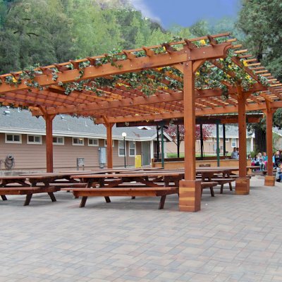Traditional Wooden Garden Pergola (Options: 30' L x 30' W, California Redwood, No Electrical Wiring Trim, Open Roof with Slats at 18", Rafters at 18", 6-Post Anchor Kit for High-Wind, No Ceiling Fan Base, No Privacy Panels, No Curtain Rods, 10' Post Height, Transparent Premium Sealant). After the tables and pavers were added. Picnic Tables are not Forever Redwood Tables. Photo Courtesy of Via West Campground located at 13851 Stevens Canyon Rd, Cupertino, CA.