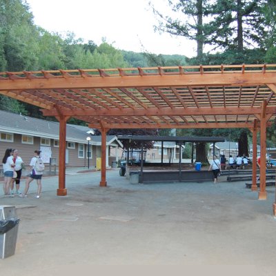 Traditional Wooden Garden Pergola (Options: 30' L x 30' W, California Redwood, No Electrical Wiring Trim, Open Roof with Slats at 18", Rafters at 18", 6-Post Anchor Kit for High-Wind, No Ceiling Fan Base, No Privacy Panels, No Curtain Rods, 10' Post Height, Transparent Premium Sealant). Before the tables and pavers were added. Photo Courtesy of Via West Campground located at 13851 Stevens Canyon Rd, Cupertino, CA.