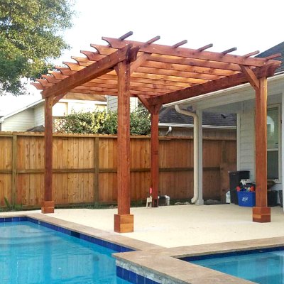 Traditional Wooden Garden Pergola (Options: 15' L x 11' W, California Redwood, No Electrical Wiring Trims, Open Roof with Slats at 18", Rafters at 18", 4-Post Anchor Kit for Concrete, No Ceiling Fan Base, No Privacy Panels, No Curtain Rods, Transparent Premium Sealant). Photo Courtesy of T. Mullin of Katy, TX.