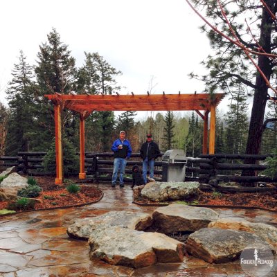 Traditional Wooden Garden Pergola (Options: 12' L x 18' W, California Redwood, No Electrical Wiring Trim, Open Roof with Slats at 18", Rafters at 18", Widthwise Roof Support Timbers, 4-Post Anchor Kit for Concrete, No Ceiling Fan Base, No Privacy Panels, No Curtain Rods, 9' Post Height, Transparent Premium Sealant). Photo Courtesy of Tim M. of Durango, CO.