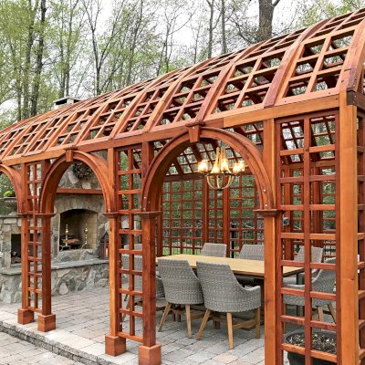 The Victorian Trellis (Options: 22' L x 14' W, Combination of Arcs and Lattice Panels, Mature Redwood, No Rain Guard, 9' Post Height, No Electrical Wiring Trim, Post Anchor Kit for Stone, No Ceiling Fan Base, Transparent Premium Sealant). Photo Courtesy of JR and Trish West of King George, Virginia.