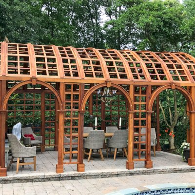 The Victorian Trellis (Options: 22' L x 14' W, Combination of Arcs and Lattice Panels, Mature Redwood, No Rain Guard, 9' Post Height, No Electrical Wiring Trim, Post Anchor Kit for Stone, No Ceiling Fan Base, Transparent Premium Sealant). Photo Courtesy of JR and Trish West of King George, Virginia.
