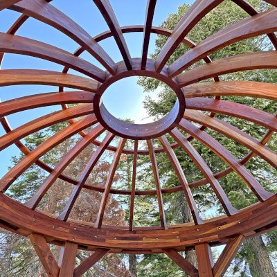 Wooden Dome Pergola (Options: 12' Diameter, Without Deck, California Redwood, Open Roof with Slats at 18", 7.5' Posts, 1 Electrical Wiring Trim, 6-Post Anchor Kit for Concrete, Transparent Premium Sealant). Photo Courtesy of G. Stratton of Stateline, NV.