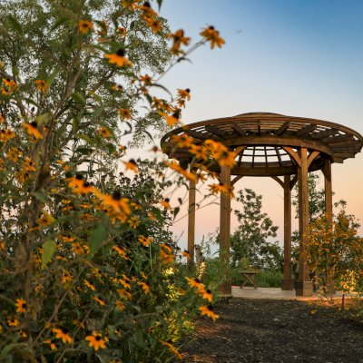 Wooden Dome Pergola (Options: 16' Diameter, Without Deck, California Redwood, Open Roof with Slats at 6", 9' Posts, No Electrical Wiring Trim, 6-Post Anchor Kit for Concrete, Transparent Premium Sealant). Photo Courtesy of P. Kawalek of Black Earth, Wisconsin.