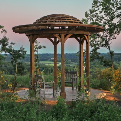 Wooden Dome Pergola (Options: 16' Diameter, Without Deck, California Redwood, Open Roof with Slats at 6", 9' Posts, No Electrical Wiring Trim, 6-Post Anchor Kit for Concrete, Transparent Premium Sealant). Photo Courtesy of P. Kawalek of Black Earth, Wisconsin.