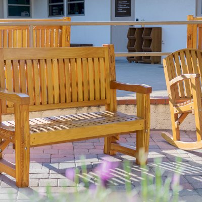 Ti Amo Benches (Options: 4 ft, Mosaic Douglas-Fir, No Cushion, No Engraving, Transparent Premium Sealant). Photo Also Shows a Luna Rocking Chair. Furniture Installed in Vanguard University [55 Fair Dr, Costa Mesa, CA].