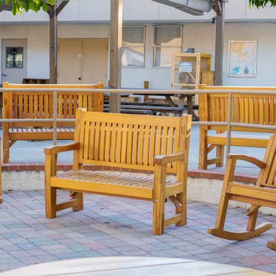 Ti Amo Benches (Options: 4 ft, Mosaic Douglas-Fir, No Cushion, No Engraving, Transparent Premium Sealant). Photo Also Shows 2 Luna Rocking Chairs. Furniture Installed in Vanguard University [55 Fair Dr, Costa Mesa, CA].
