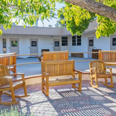 Ti Amo Benches (Options: 4 ft, Mosaic Douglas-Fir, No Cushion, No Engraving, Transparent Premium Sealant). Photo Also Shows 2 Luna Rocking Chairs. Furniture Installed in Vanguard University [55 Fair Dr, Costa Mesa, CA].