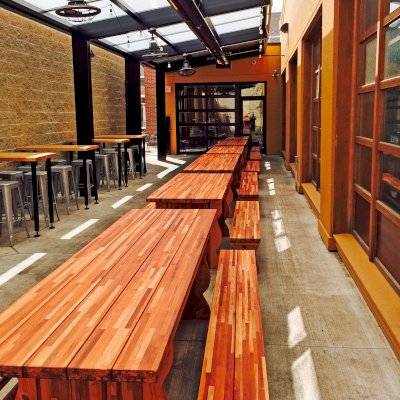 Trestle Natural Wood Outdoor Table (Options: 8' L, 34 1/2'' W Tabletop, Side Benches, Mosaic Redwood, Standard Tabletop, Slightly Rounded Corners, 1 Full Length Side Benche Per Side, No Umbrella Hole, Transparent Premium Sealant). Photo Courtesy of Jason Spaulding of Grand Rapids, Michigan.