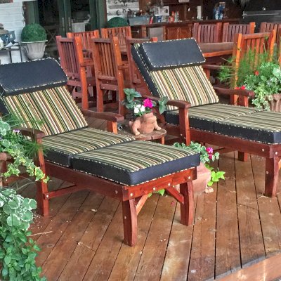 Wood Pool Lounger (Options: Single, Standard 74", Mature Redwood, 13" H, Include Wooden Wheels, Transparent Premium Sealant). A San Francisco Patio Table Set in Background. Photo Courtesy of Charles Fronheiser.