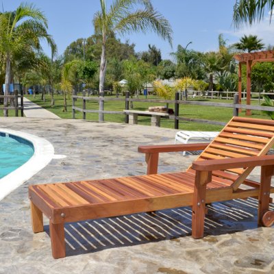 Wood Pool Lounger (Options: Single, Standard 74", Redwood, 13" H, Include Wooden Wheels, Transparent Premium Sealant). La grange style armrests & 54" L bed by custom request. Photo also shows The Fan Pergola in the background. 